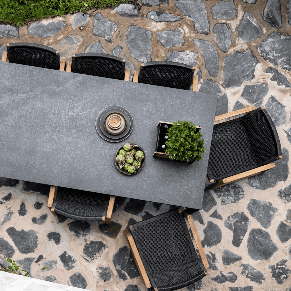 Boxhill's Endless Outdoor Dining Armchair lifestyle image with dining table, top view at patio