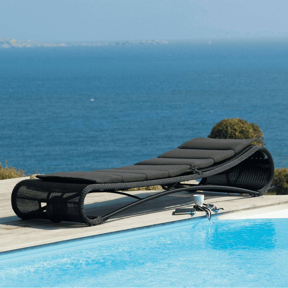 Boxhill's Escape Pool Side Sunbed Black Weave with Black Cushion lifestyle image beside the pool