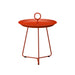 Orange round metal outdoor tray table circular handle at the center on a white background