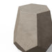 Close-up of a gray textured geometric concrete outdoor side table or stool with faceted design against white background