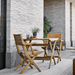 Boxhill's Flip Folding Outdoor Teak Dining Table Small lifestyle with Flip Folding Outdoor Teak Dining Armchair beside the wall at patio