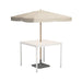 White square outdoor dining table mounted with beige patio umbrella with wooden pole