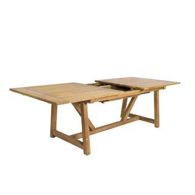 Natural teak outdoor extendable dining table in a light brown finish featuring a rectangular slatted top.