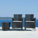 Boxhill's Hampsted Outdoor Dining Armchair lifestyle image with Kingston Outdoor Footstool | Side Table at seafront