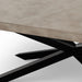 Close-up of gray rectangular concrete outdoor dining table with black angular metal legs on a plain white surface