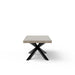 Side view of rectangular outdoor dining table with concrete top and black angular steel legs on a white background
