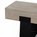 Close-up of gray concrete concrete outdoor bench with black steel legs against white background