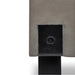 Close-up of concrete outdoor side table or stool with black metal legs against plain white background