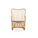 Natural rattan outdoor lounge chair with white cushion featuring curved arms and an open woven back.