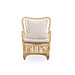 Natural rattan outdoor lounge chair in a light tan finish with white cushions and curved arms.