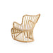 Natural rattan outdoor lounge chair viewed from the rear featuring an open woven back and curved base rails.