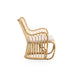 Natural rattan outdoor lounge chair viewed from the side with white cushion and curved base rails.