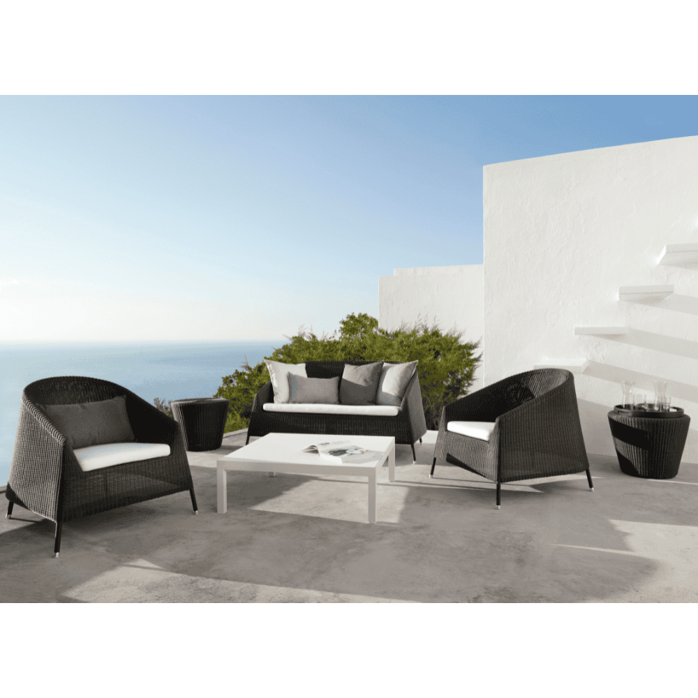 Boxhill's Kingston Outdoor Footstool | Side Table lifestyle image with Kingston Outdoor Stackable Lounge Chair and   Kingston Stackable Outdoor 2-Seater Sofa at patio