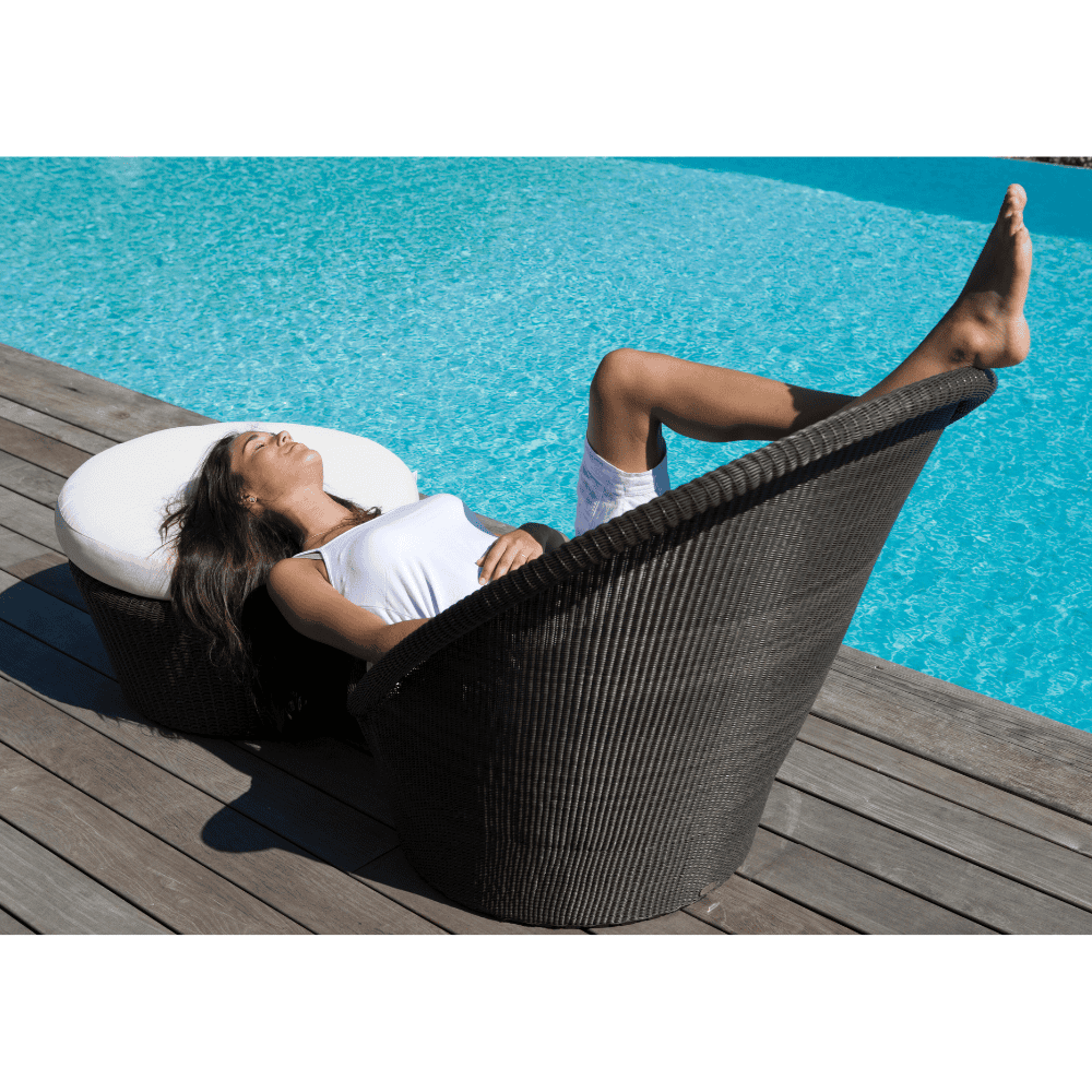 Boxhill's  Kingston Sunchair Lounge with Wheels lifestyle image with  Kingston Outdoor Footstool | Side Table on a wooden poolside with a woman lying down