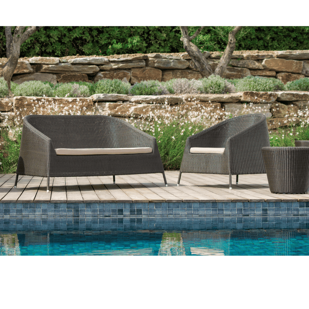 Boxhill's Kingston Stackable Outdoor 2-Seater Sofa lifestyle image with Kingston Outdoor Stackable Lounge Chair and Kingston Outdoor Footstool | Side Table at poolside