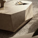 Gray textured geometric concrete coffee table with magazine and vase on top of a gray rug