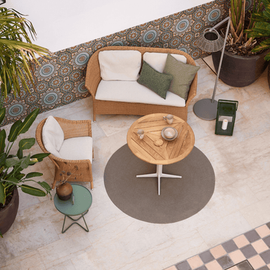 Boxhill's Lansing Outdoor 2-Seater Sofa Natural lifestyle image with Lansing Outdoor Lounge Chair and teak round table at patio top view