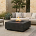 Outdoor patio with square concrete black fire pit table and beige sofa