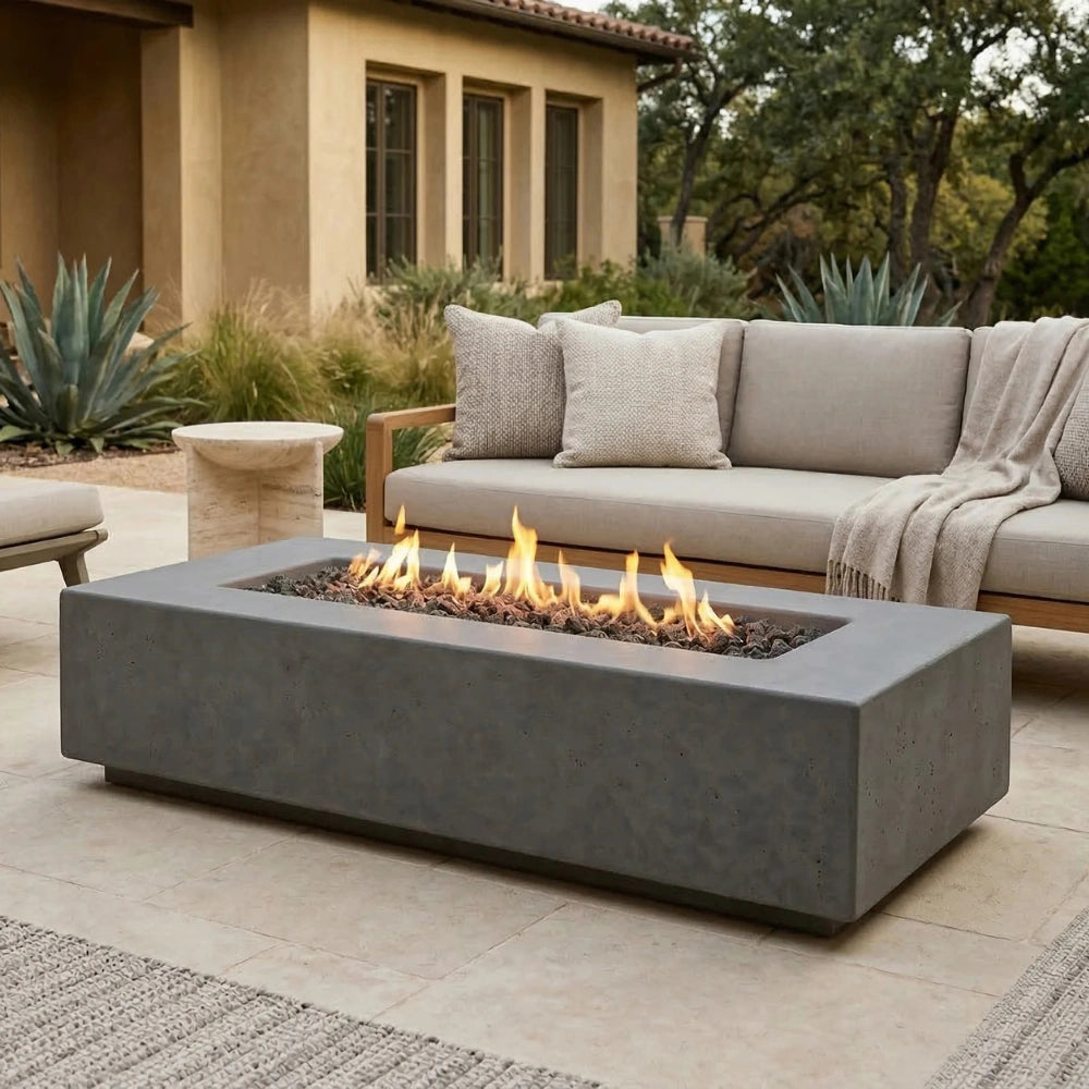 Outdoor patio with a grey rectangular concrete fire pit table and seating area.