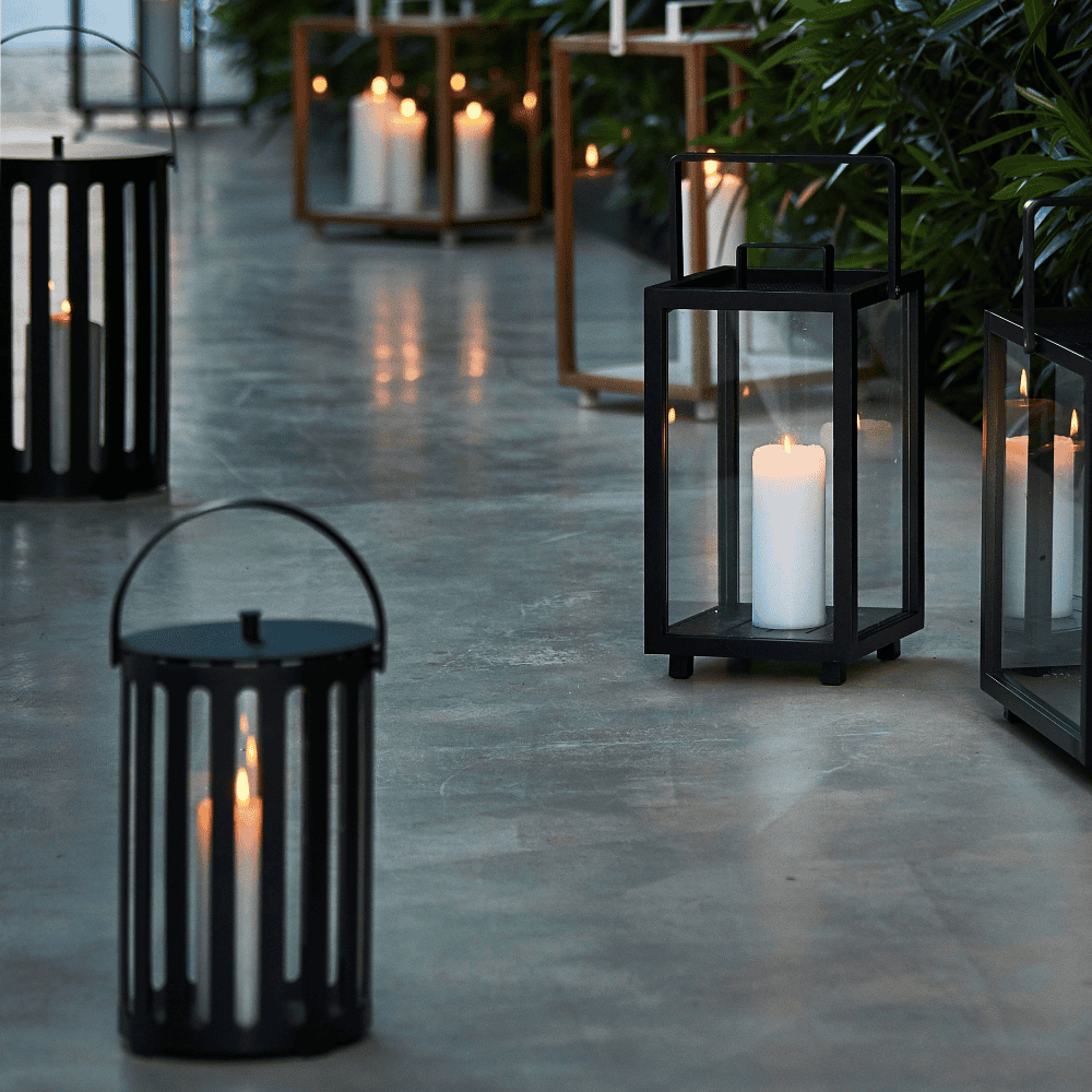 Boxhill's Lighttube Outdoor Large Lantern | Set of 2 lifestyle image with Lighthouse Outdoor Large Aluminum Lantern and Lighthouse Outdoor Large Teak Lantern at patio