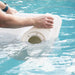 Person hands filling a white in-pool chaise with water in a swimming pool.