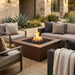 Outdoor patio with outdoor brown square fire pit table and comfortable seating area.