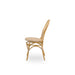 Natural rattan outdoor dining side chair viewed from the side with a woven wicker seat and double-loop backrest.
