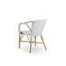 Angled rear view of white rattan outdoor dining armchair featuring a black and white woven wicker seat and back.