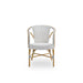 White rattan outdoor dining armchair featuring a black and white woven wicker seat and back.