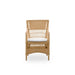 Natural rattan outdoor dining armchair with a white cushion and an open woven frame.