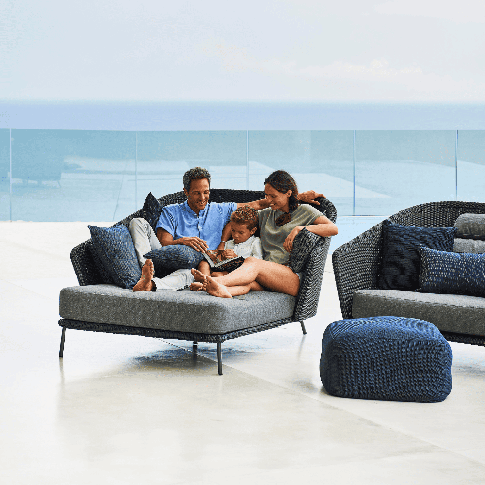 Boxhill's Mega Modern Outdoor Right Module Daybed lifestyle image with a family sitting down reading a book