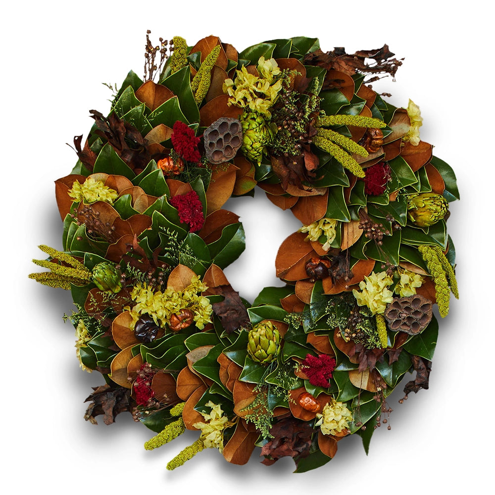 Festive wreath made of green and brown leaves with dried flowers, seed pods, and natural elements