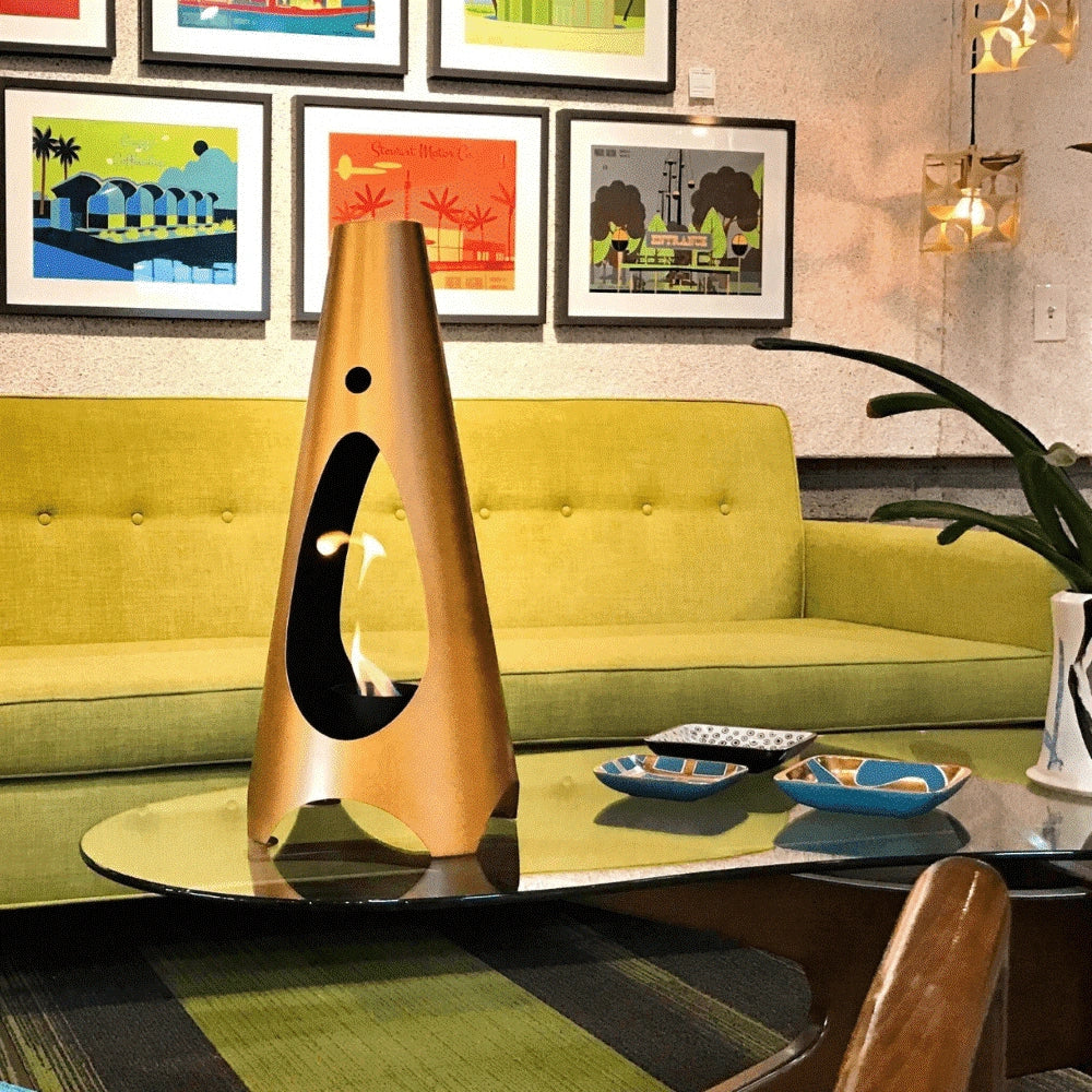  Gold cone shaped mini metal fire pit placed over a glass table near a yellow sofa inside a room
