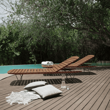 2 bamboo lamellas outdoor sunbed with black metal frame placed on a wooden deck beside the pool