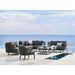 Boxhill's Moments Outdoor Lounge Chair lifestyle image with Moments Module Sofa Collection and Level Coffee Table beside the pool