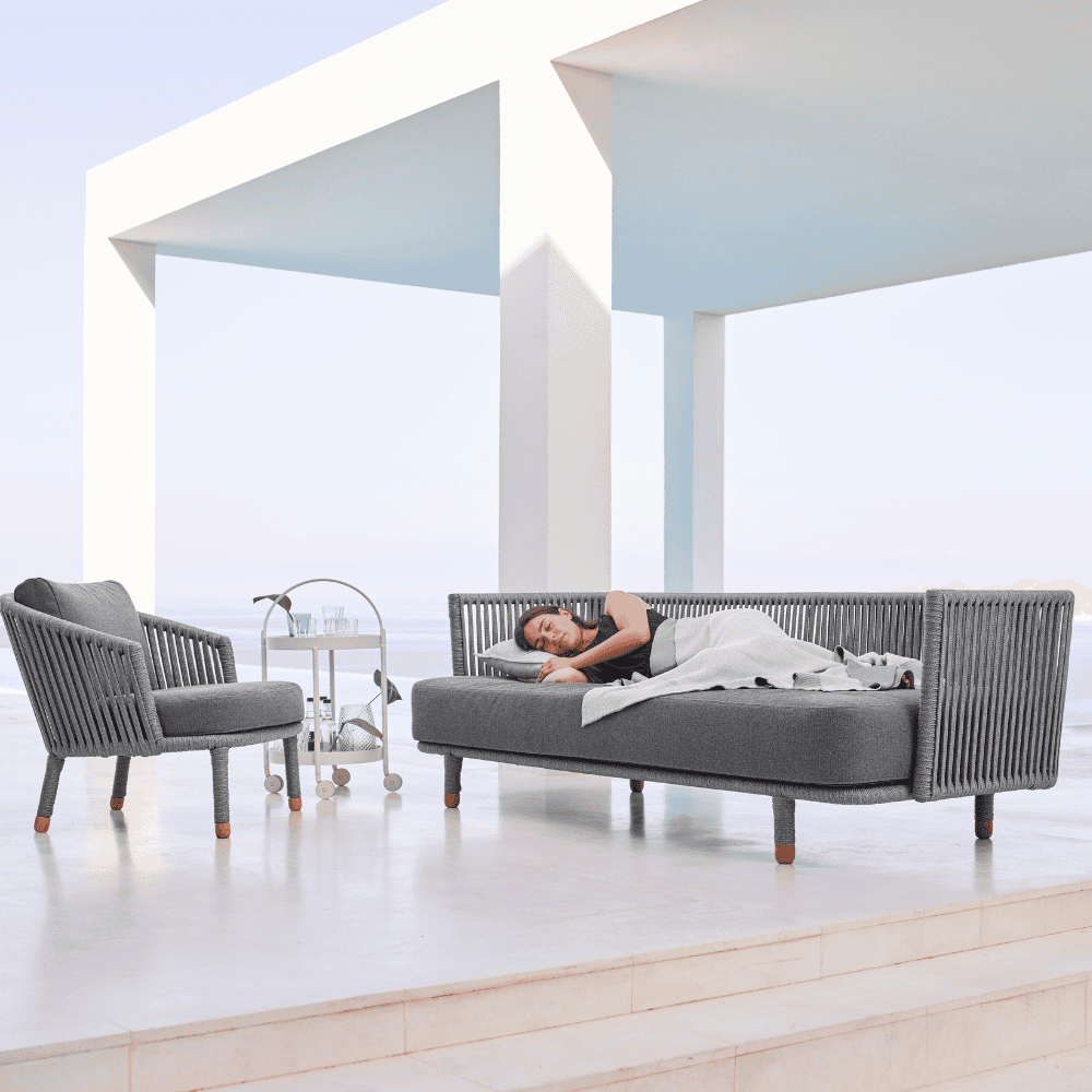 Boxhill's Moments 3-Seater Sofa lifestyle image with Moments Outdoor Lounge Chair and a woman sleeping