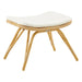 Natural rattan outdoor footstool in a light tan finish with a white cushion.