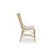 Natural rattan outdoor dining side chair viewed from the side with black and white woven wicker seat and back.