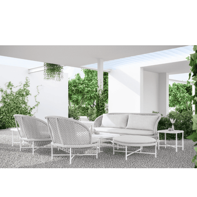 Boxhill's Montauk Outdoor Club Chair lifestyle image with Montauk 3 Seat Sofa, Montauk Ottoman, and Hampton Coffee Table and Side Table