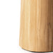 Close-up of a cylindrical wooden object, showing a light natural wood grain surface against a white background.
