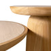 Close-up of a light natural wood stool or table leg with a rounded seat, shown against a clean white background.