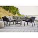 Boxhill's Ocean Outdoor Corner Sofa Module lifestyle image with other Ocean Module Sofa and Chair Collection, and a round table on wooden platform beside seashore