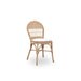 Natural rattan outdoor dining side chair with a white cushion featuring an open woven back.