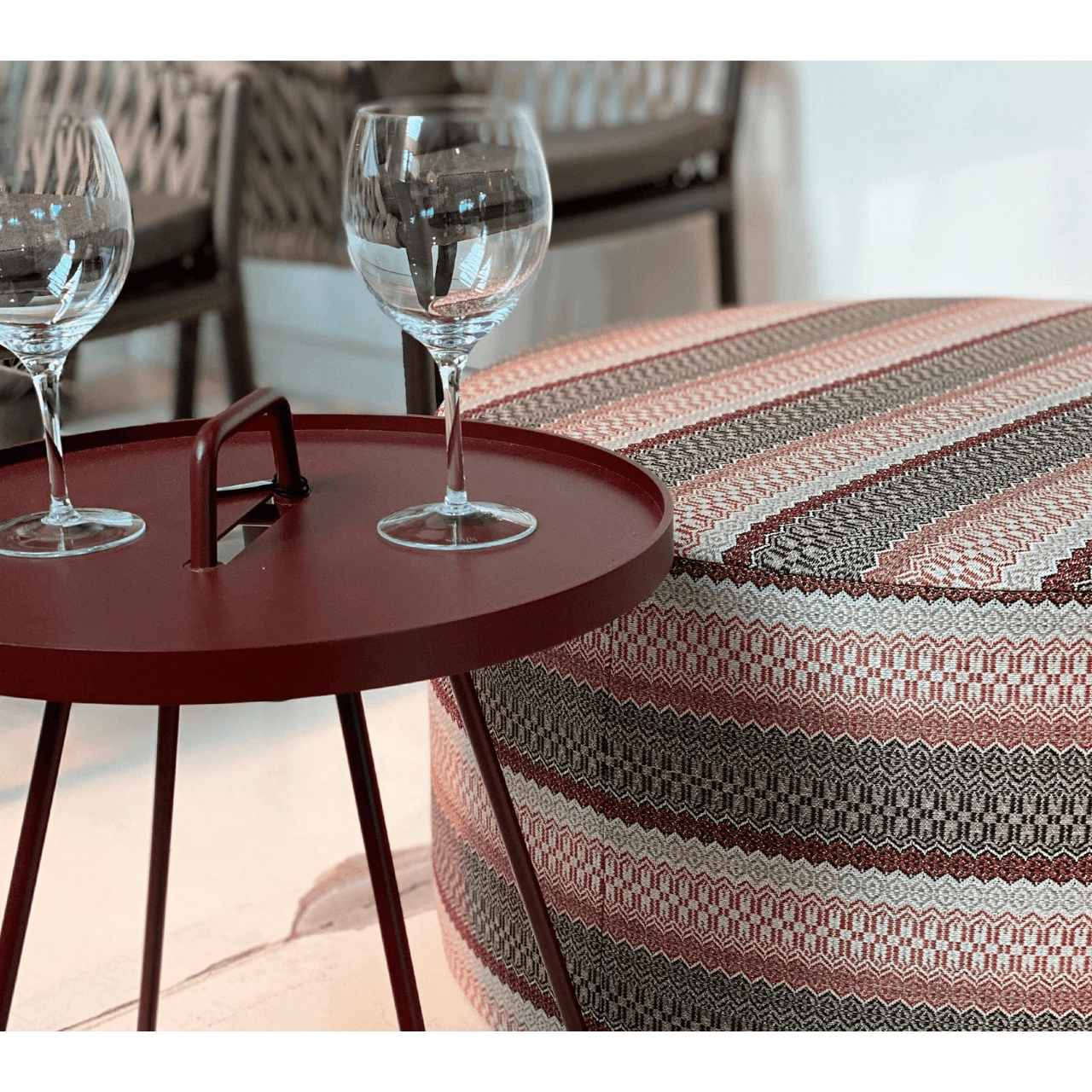  Boxhill's On-The-Move maroon outdoor round side tabe with 2 glasses on it beside outdoor fabric stool