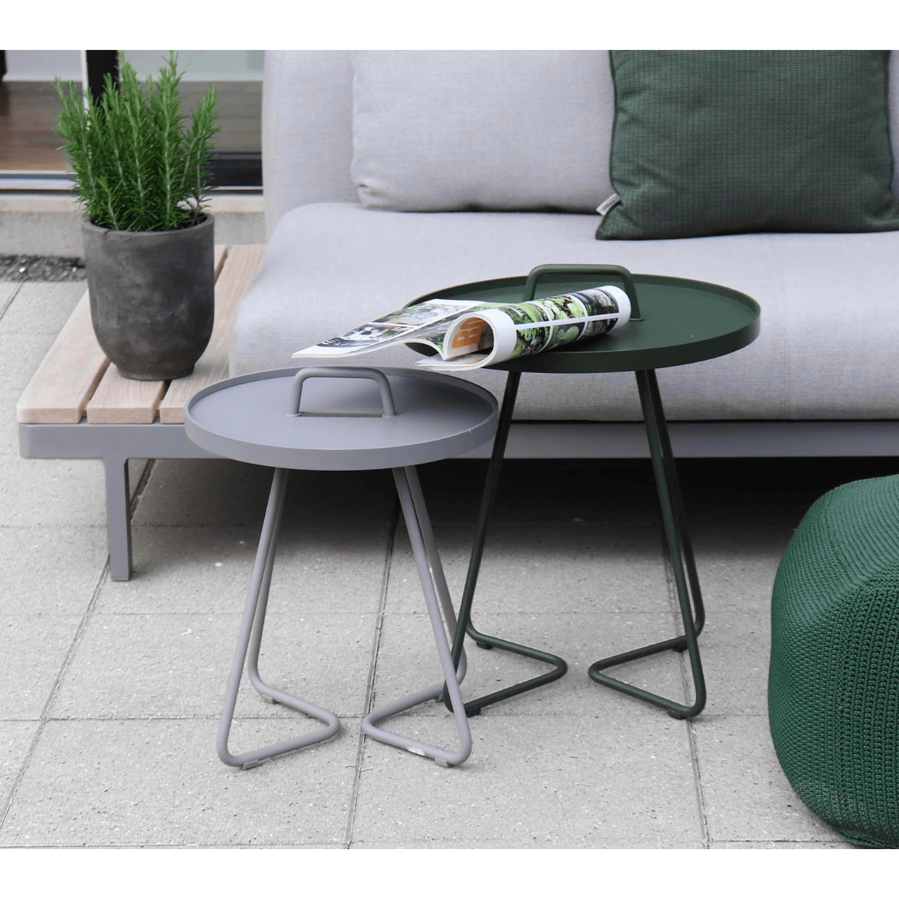 Boxhill's On-the-Move light grey and dark green outdoor round side table beside dark green outdoor fabric footstool in front of light grey couch