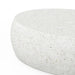 Close view of white speckled concrete pebble outdoor coffee table on a white background