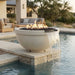 Outdoor round concrete white fire pit with built in water feature by a pool