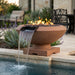 Outdoor terracotta color concrete fire pit with water feature next to a pool
