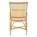 Natural rattan outdoor dining side chair featuring an open woven back viewed from the rear.