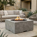 Outdoor patio with a square concrete outdoor fire pit table and seating area.
